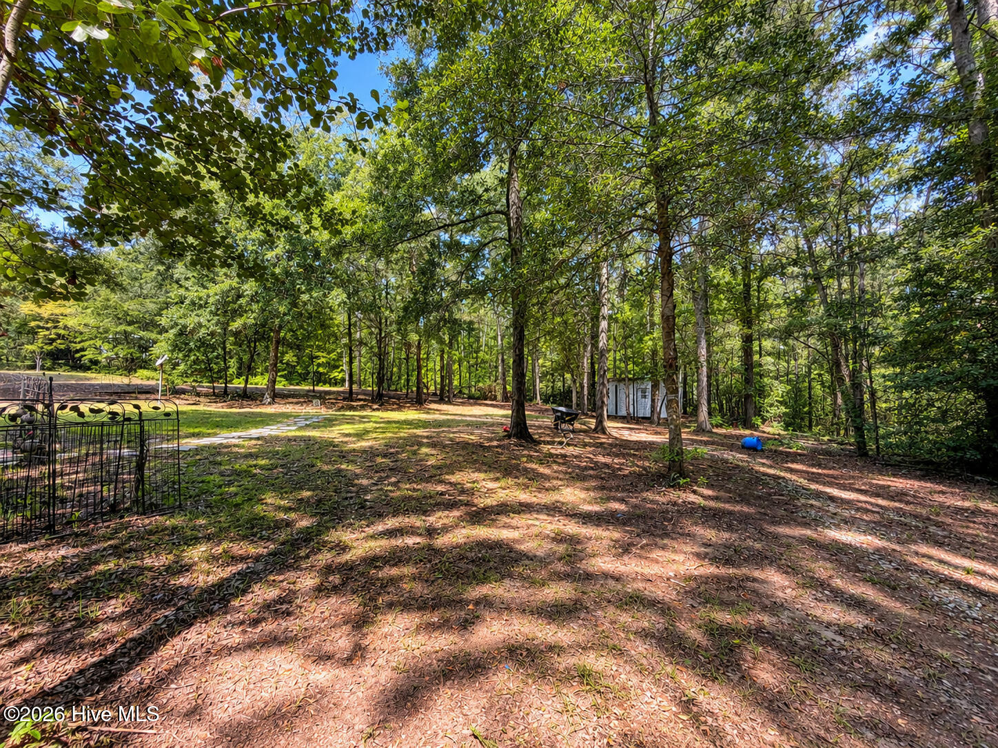 3523 Deerfield Road Dearing, GA 30808 - Photo 9 of 39 Outside, the wooded acreage creates a private, natural backdrop with plenty of room to enjoy the outdoors. Relax or entertain beneath the covered pergola patio, take advantage of the outbuilding for additional storage