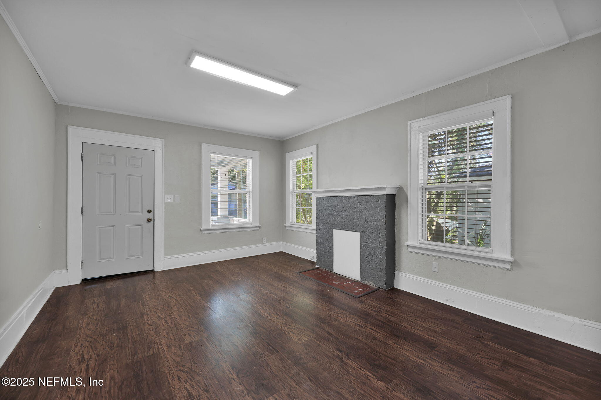 2915 Fitzgerald Street Jacksonville, FL 32254 - Photo 7 of 32 a view of an empty room with wooden floor and a window