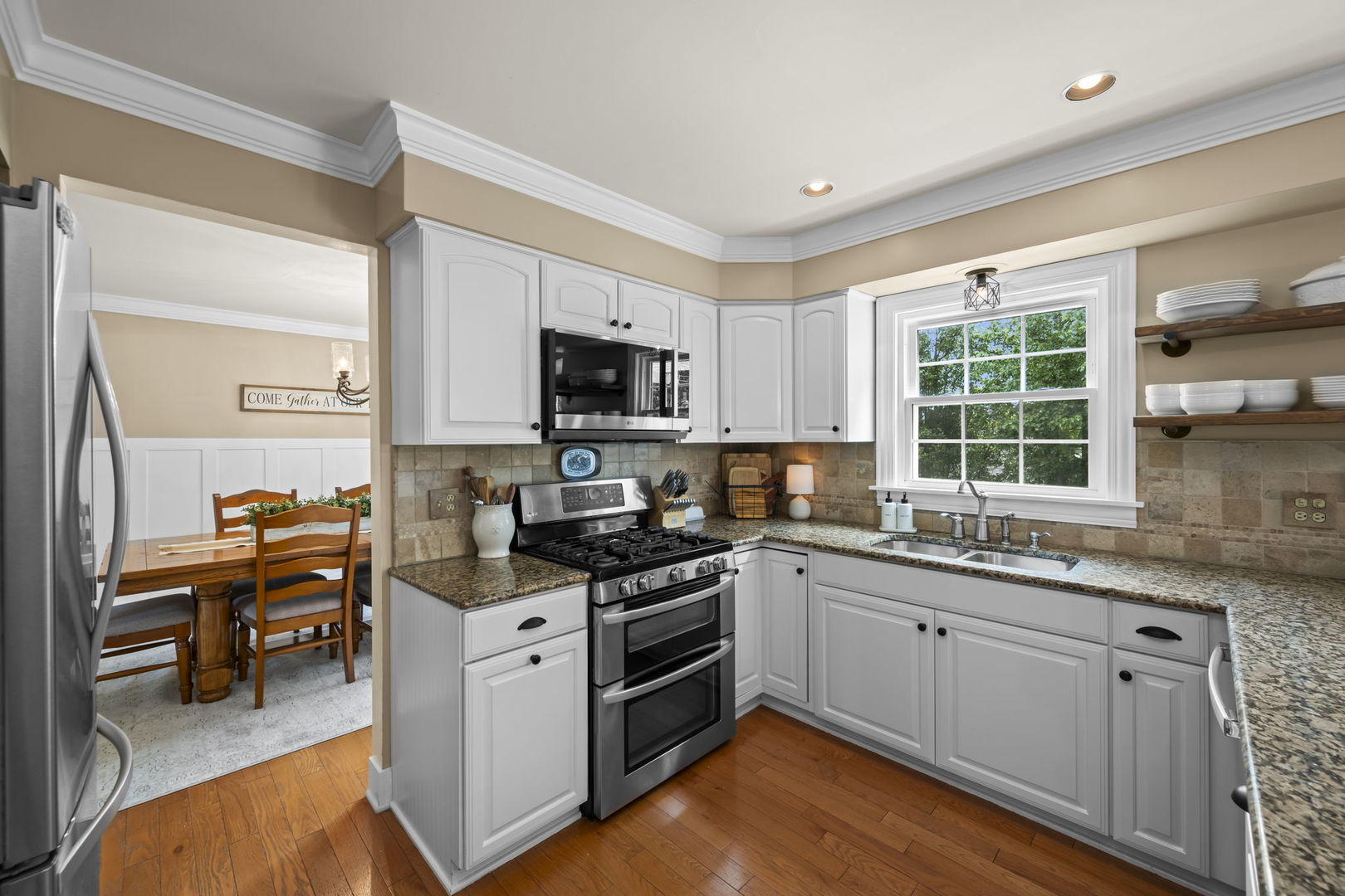 1565 Freeman Road Hoffman Estates, IL 60192 - Photo 19 of 46 a kitchen with stainless steel appliances a stove sink microwave and cabinets