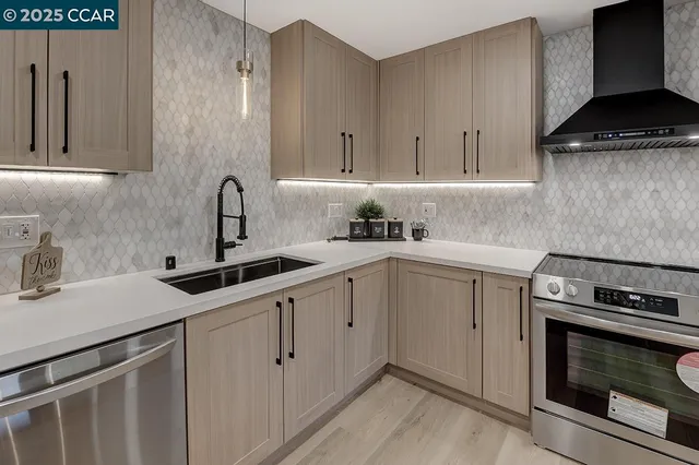 a kitchen with a sink stove and cabinets