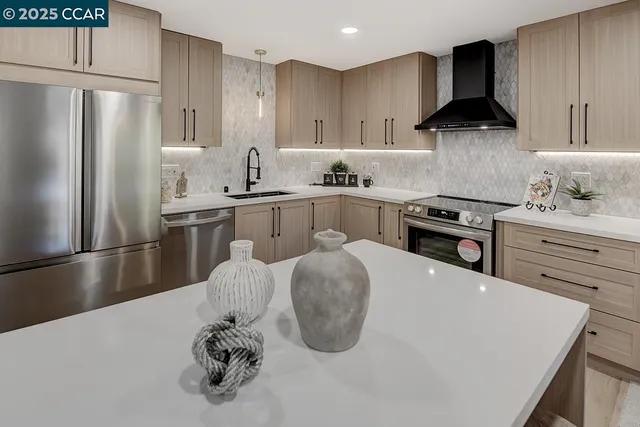 a kitchen with stainless steel appliances granite countertop a sink stove and refrigerator