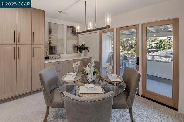 a dining room with furniture a chandelier and window