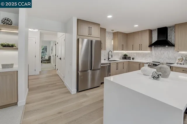 a kitchen with stainless steel appliances a refrigerator stove and sink