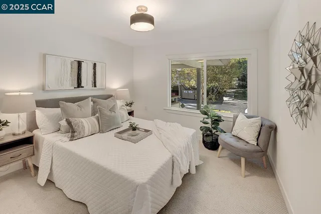 a bedroom with bed and a large window