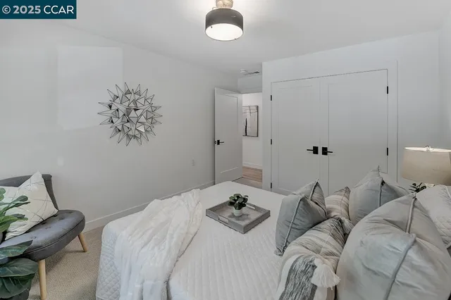 a bedroom with a bed and a chandelier