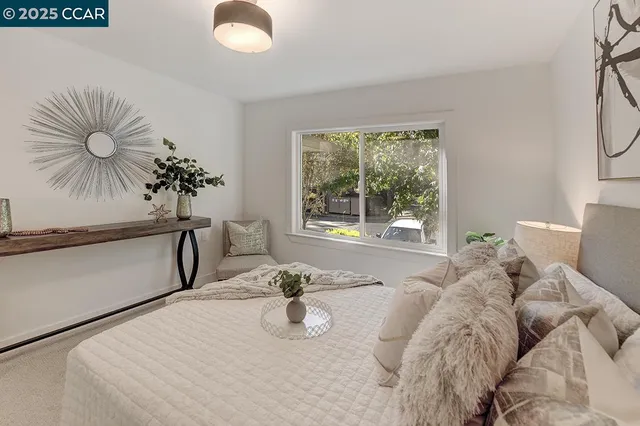 a bed sitting in a bedroom next to a window