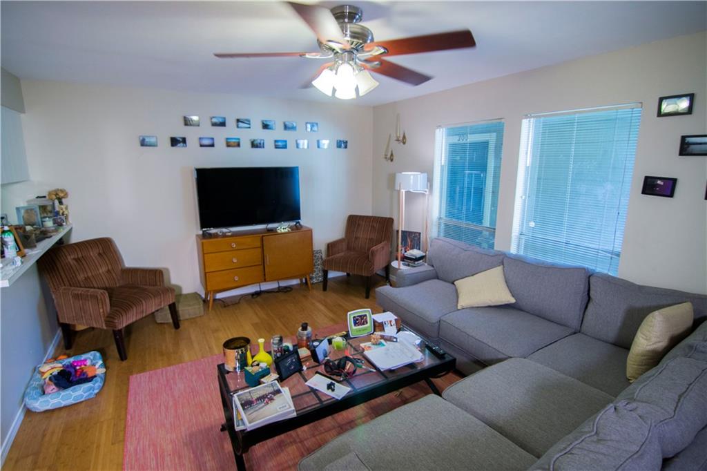 202 East 45th Street, Unit 203 Austin, TX 78751 - Photo 2 of 20 a living room with furniture and a flat screen tv