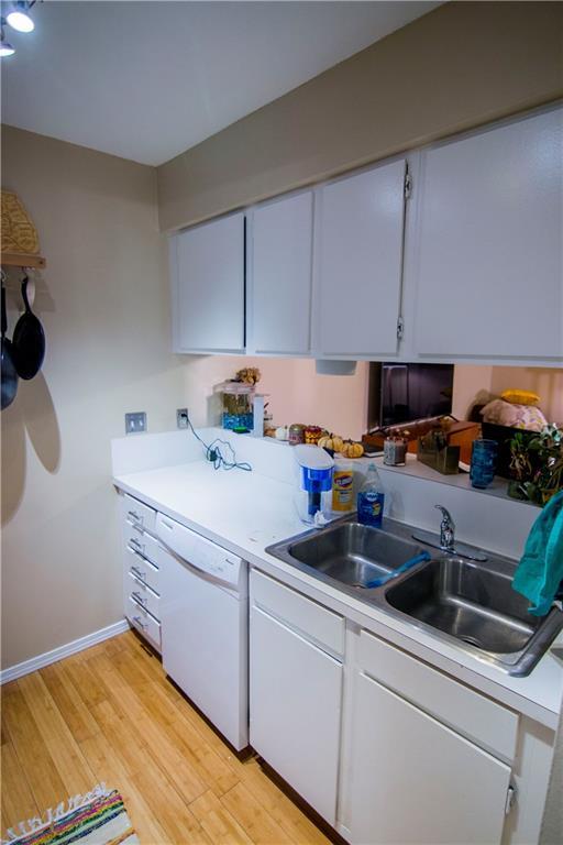 202 East 45th Street, Unit 203 Austin, TX 78751 - Photo 4 of 20 a kitchen with stainless steel appliances granite countertop a sink a stove and cabinets