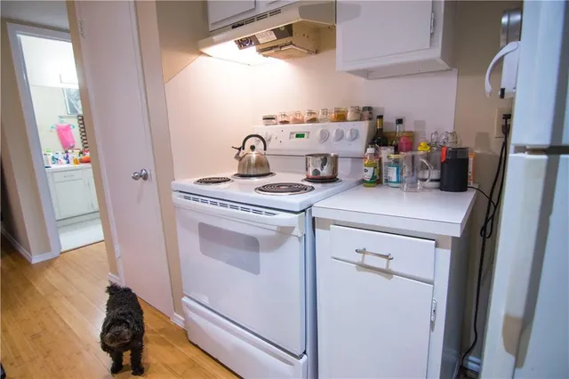 a kitchen with a sink stove and refrigerator