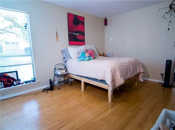 a bedroom with a bed and a fireplace