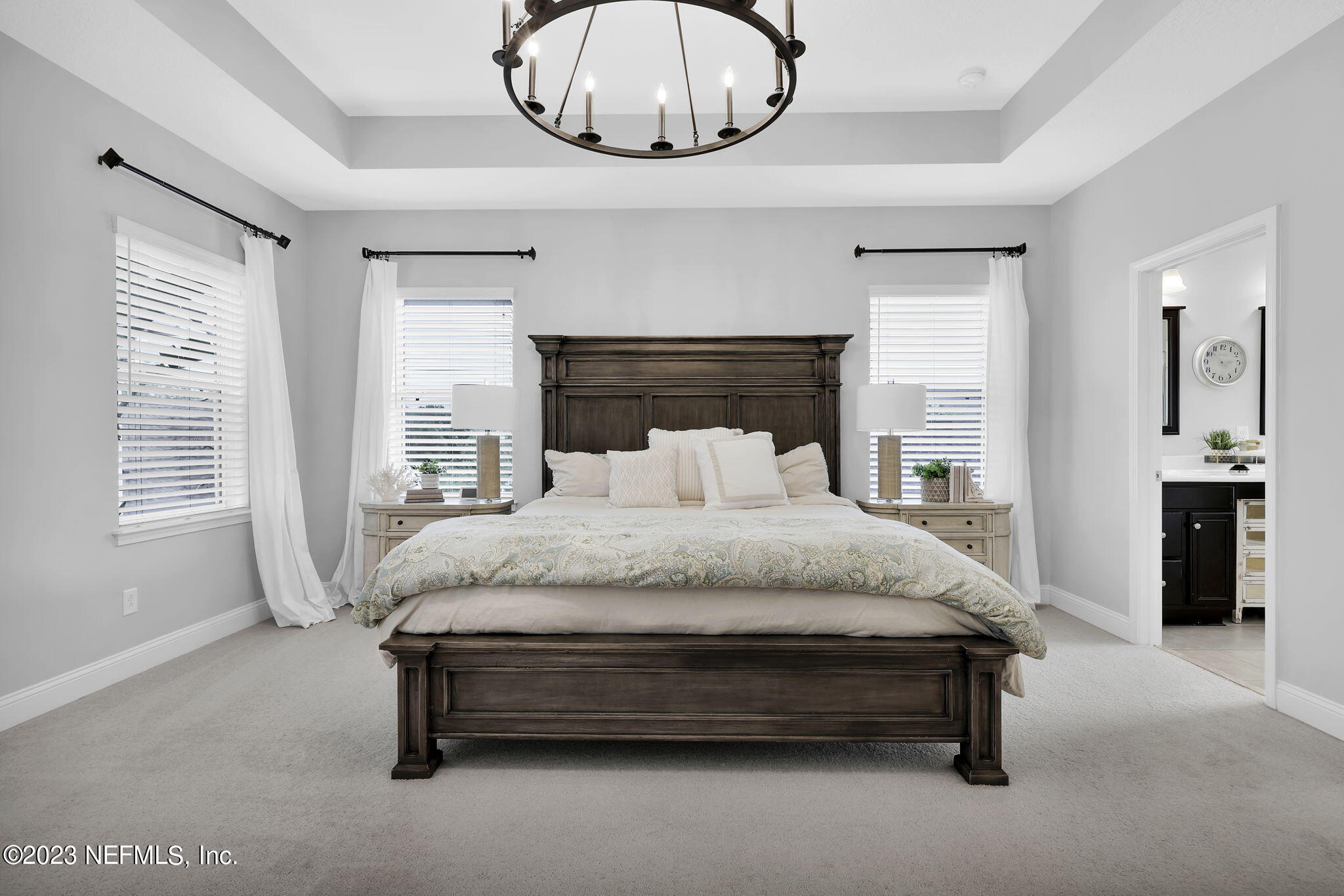 141 Pelican Pointe Road Ponte Vedra, FL 32081 - Photo 25 of 80 a spacious bedroom with a bed and a chandelier