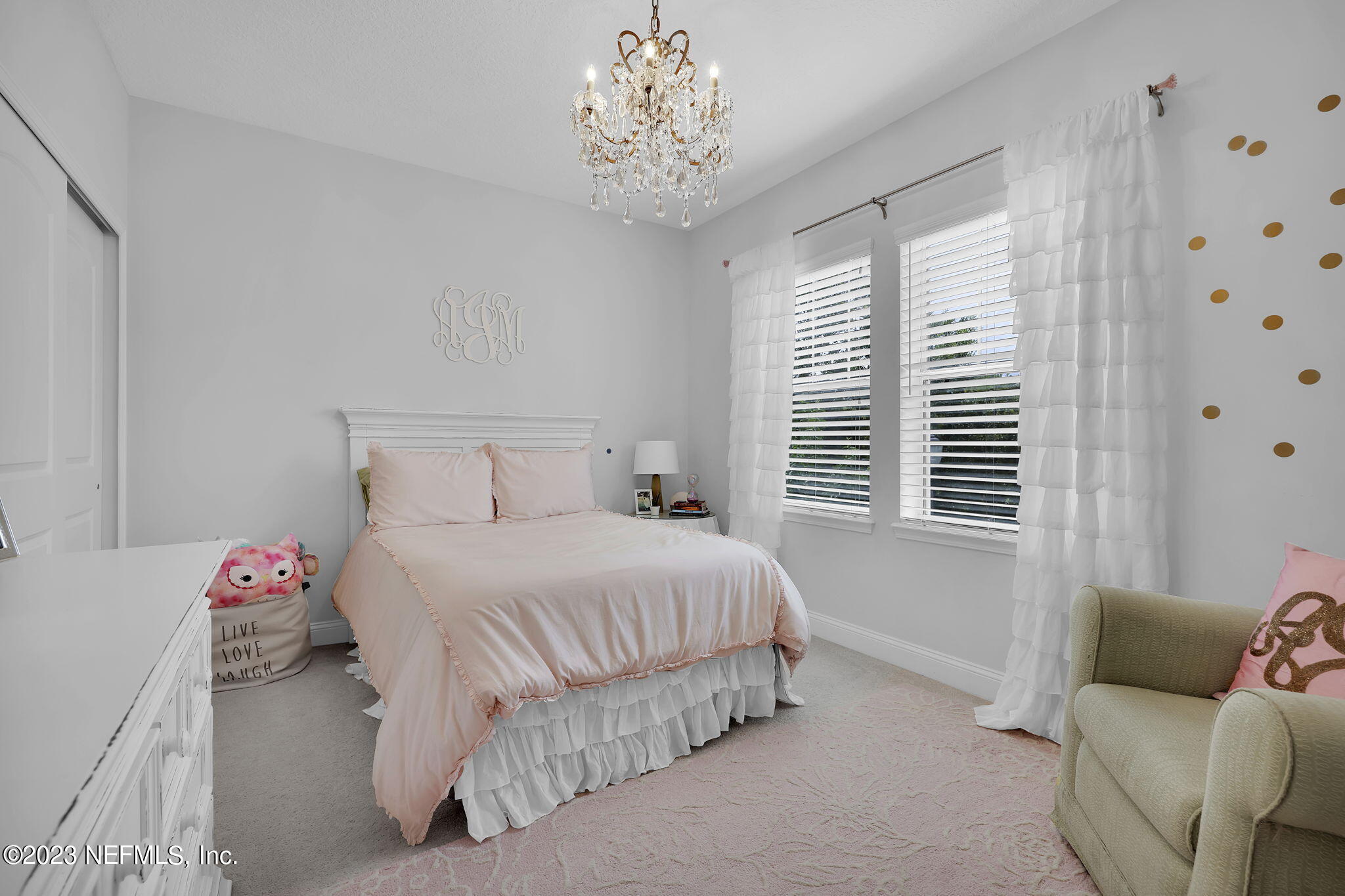 141 Pelican Pointe Road Ponte Vedra, FL 32081 - Photo 30 of 80 a bedroom with a bed and a chandelier