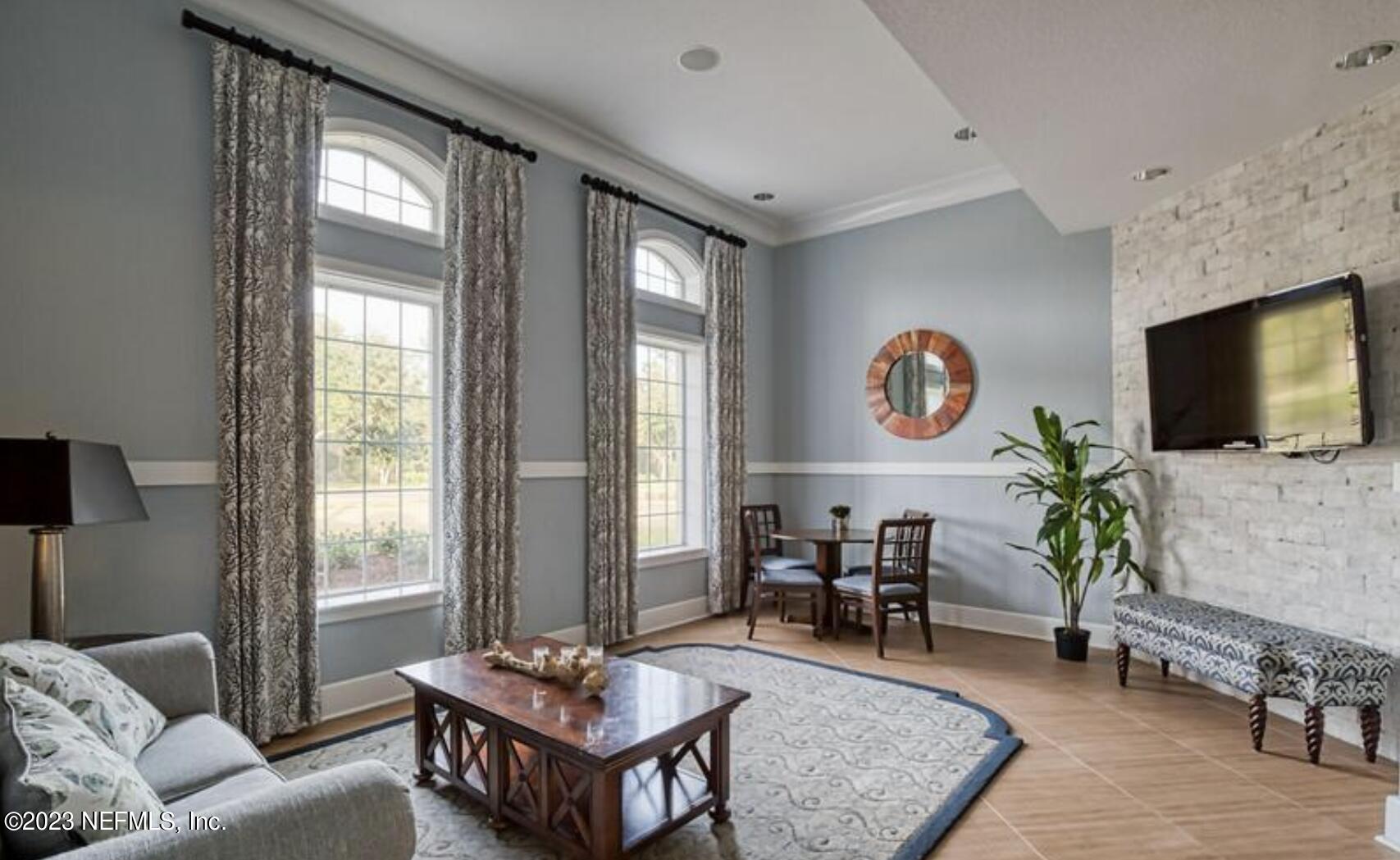 141 Pelican Pointe Road Ponte Vedra, FL 32081 - Photo 43 of 80 a living room with furniture and a flat screen tv