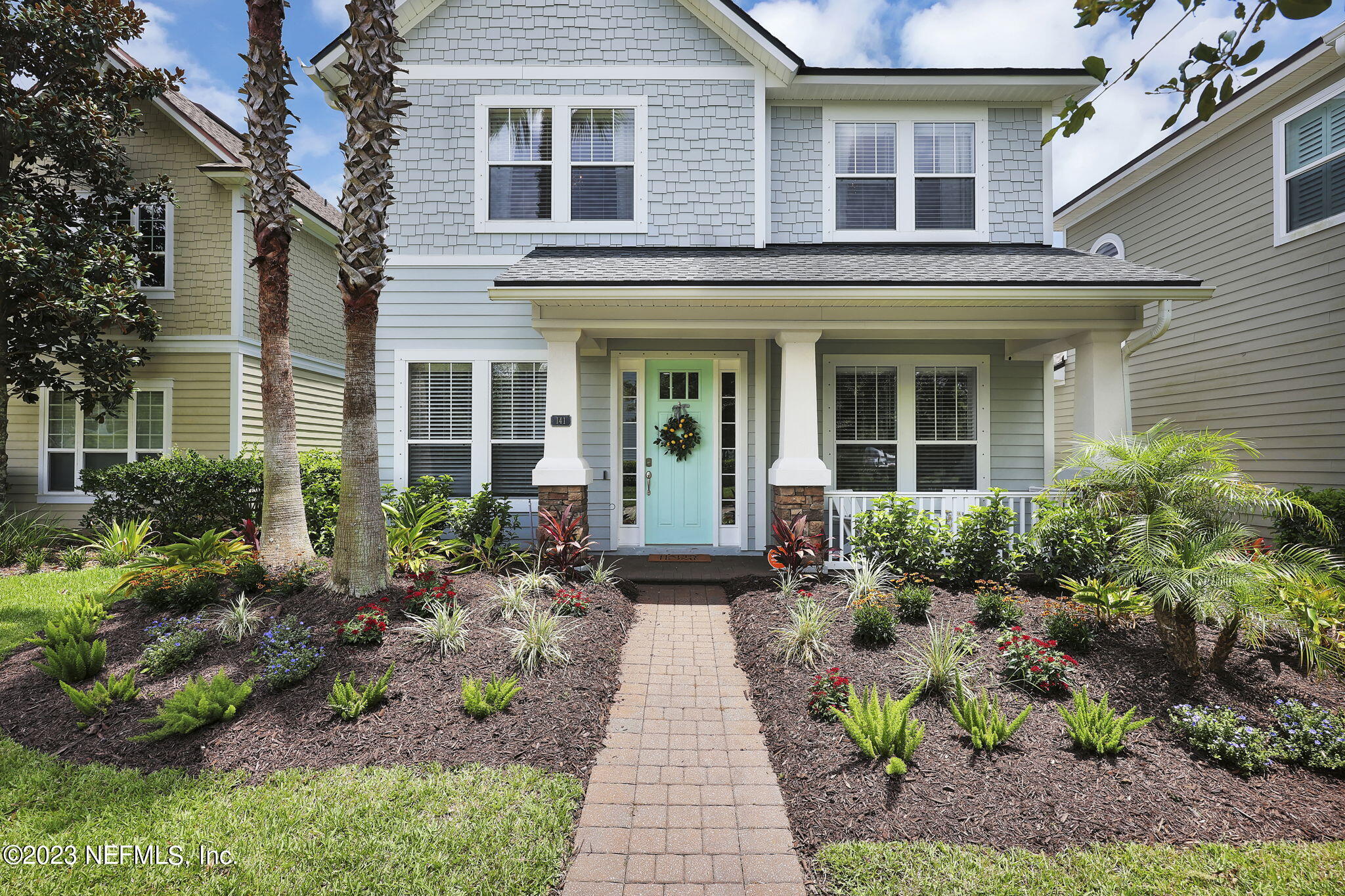 141 Pelican Pointe Road Ponte Vedra, FL 32081 - Photo 5 of 80 a view of a brick house with many windows plants and large tree