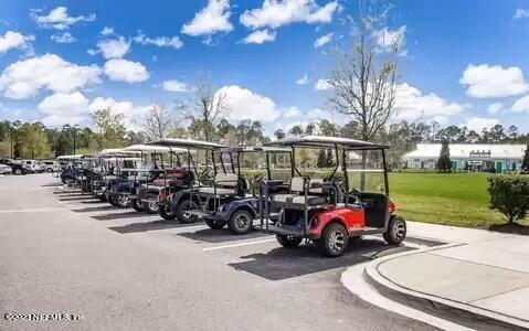 141 Pelican Pointe Road Ponte Vedra, FL 32081 - Photo 58 of 80 a view of a patio with table and chairs under an umbrella with large trees