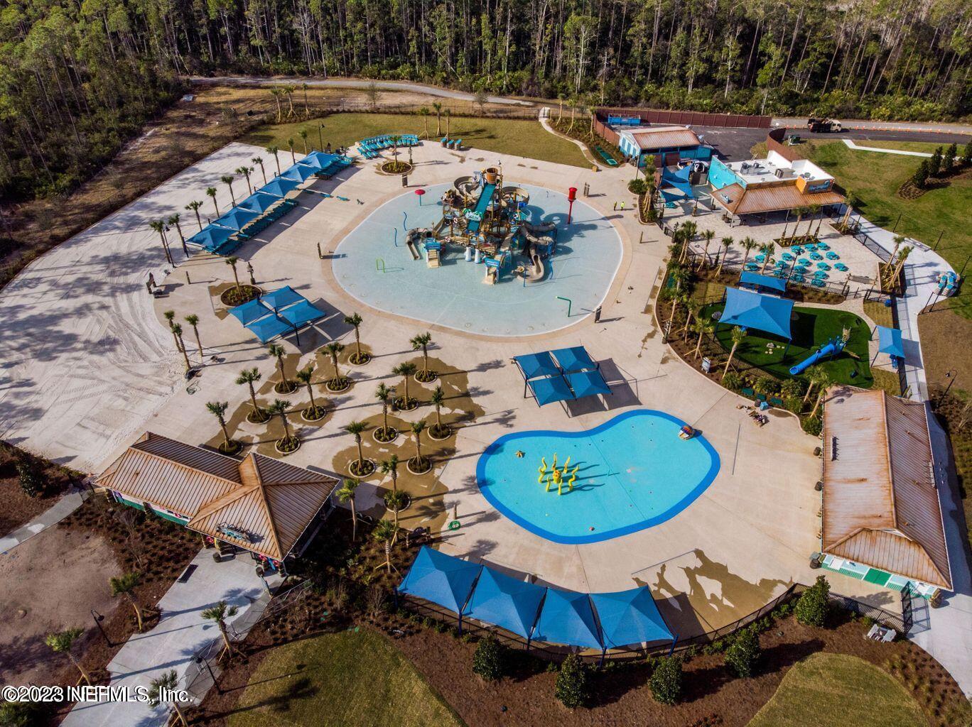 141 Pelican Pointe Road Ponte Vedra, FL 32081 - Photo 70 of 80 an aerial view of a swimming pool with a yard and seating