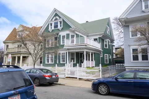 a front view of a house with parking space