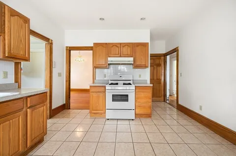 a kitchen with stainless steel appliances a stove a sink and a refrigerator