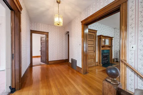a view of a room with wooden floor and windows