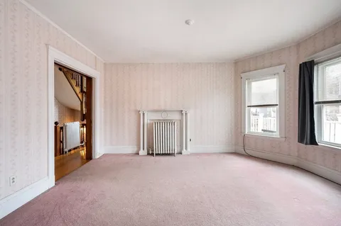 an empty room with windows and closet