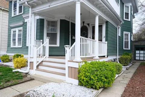 a front view of a house with a garden