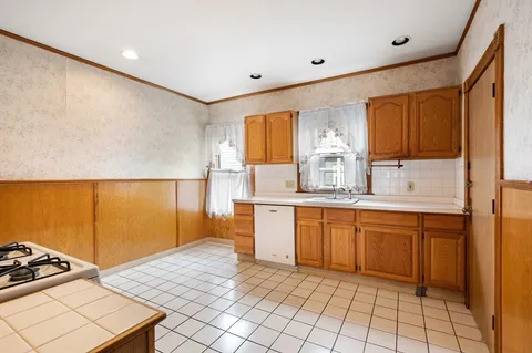 a kitchen with granite countertop a sink cabinets and window