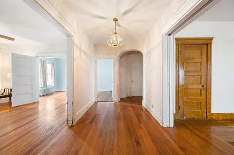 a view of hallway with wooden floor