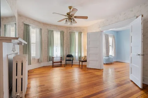 a view of livingroom with hardwood floor and a ceiling fan