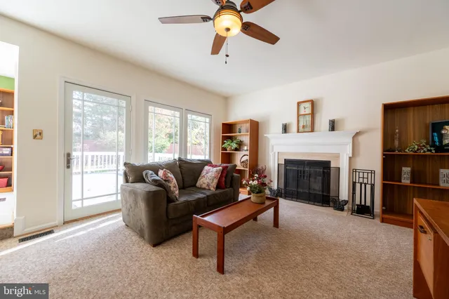 a living room with furniture fireplace and a flat screen tv