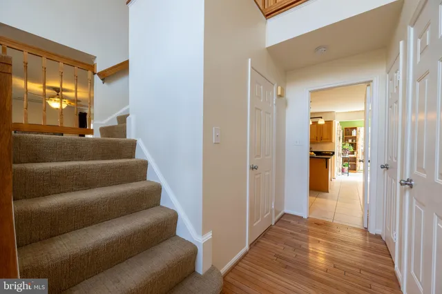 a view of a hallway with closet and wooden floor