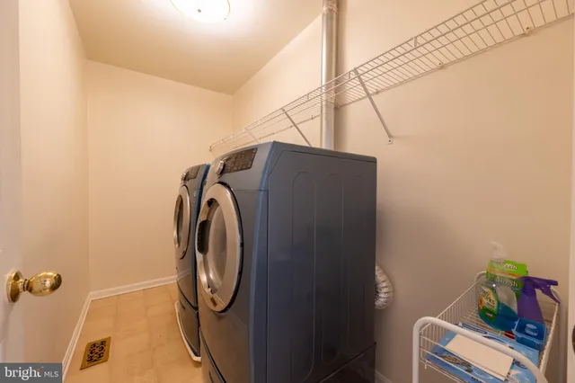 a view of an empty room with a fireplace and a cabinet