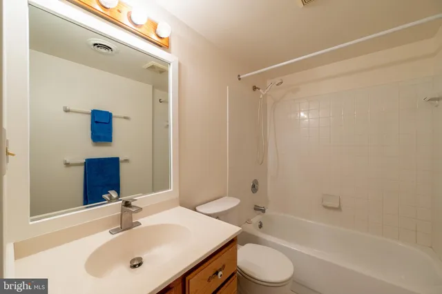 a bedroom with bed and a potted plant