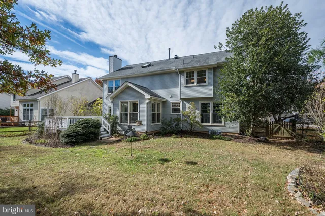 a view of a livingroom with furniture wooden floor and staircase