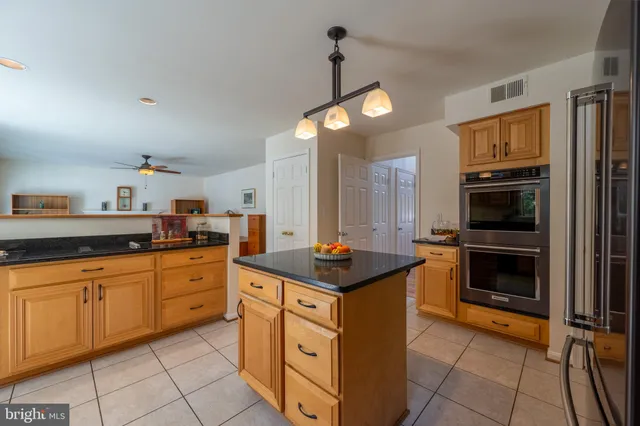 a kitchen with granite countertop a sink and cabinets