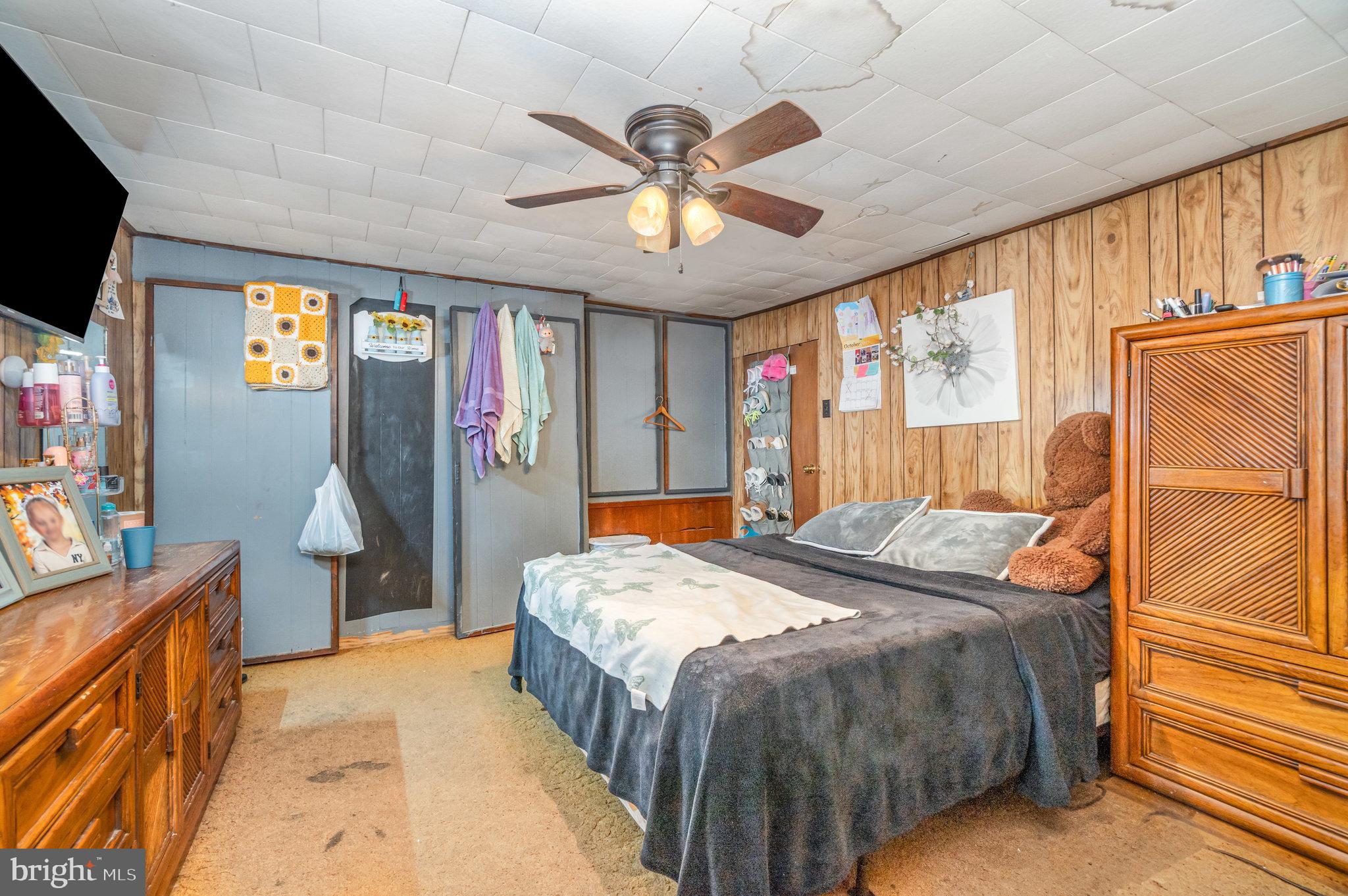 137 Oak Flat Road Newville, PA 17241 - Photo 12 of 36 a spacious bedroom with a bed and a flat tv screen on dresser