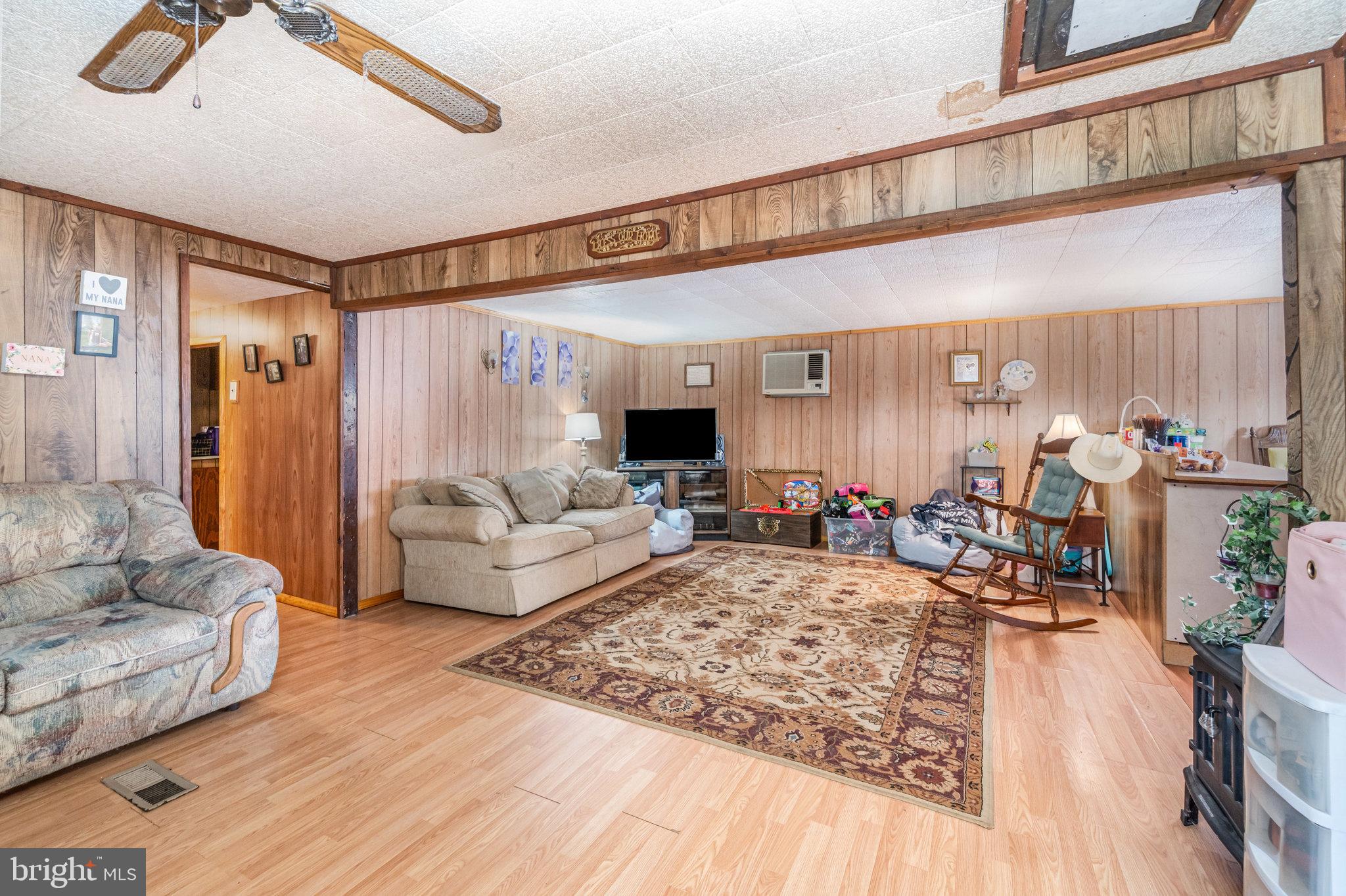 137 Oak Flat Road Newville, PA 17241 - Photo 5 of 36 a living room with furniture and a flat screen tv