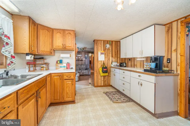 a kitchen with stainless steel appliances a refrigerator sink and cabinets