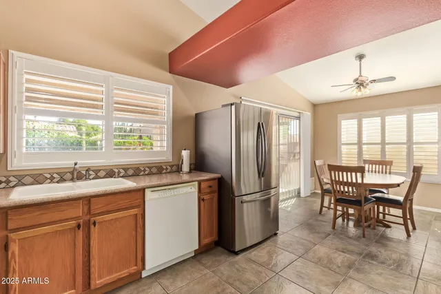 a bedroom with a bed and a chandelier fan