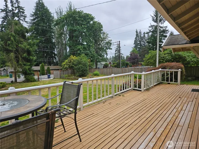 a view of balcony with wooden floor and outdoor seating