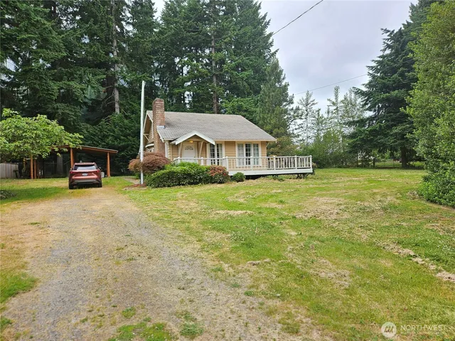 a house that has a tree in front of it