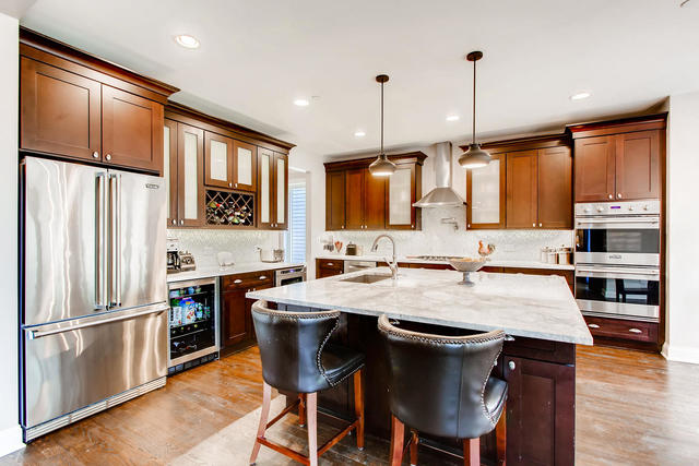 462 Northgate Court Riverside, IL 60546 - Photo 9 of 36 a kitchen with stainless steel appliances granite countertop a stove a refrigerator a sink a stove and white cabinets with wooden floor