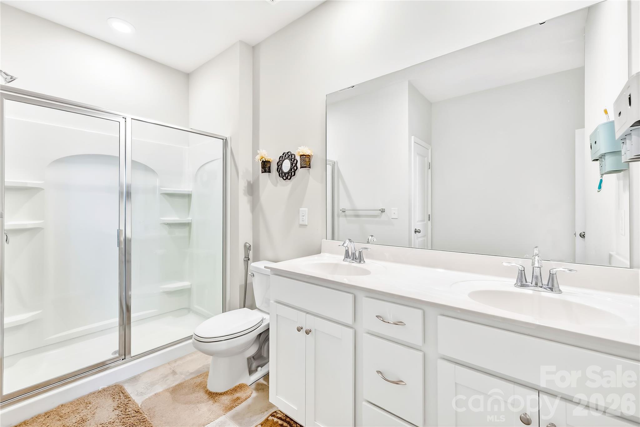 1741 Wildwood Terrace Trail Fort Mill, SC 29708 - Photo 21 of 47 a bathroom with a granite countertop sink toilet a large mirror a shower and a bathtub