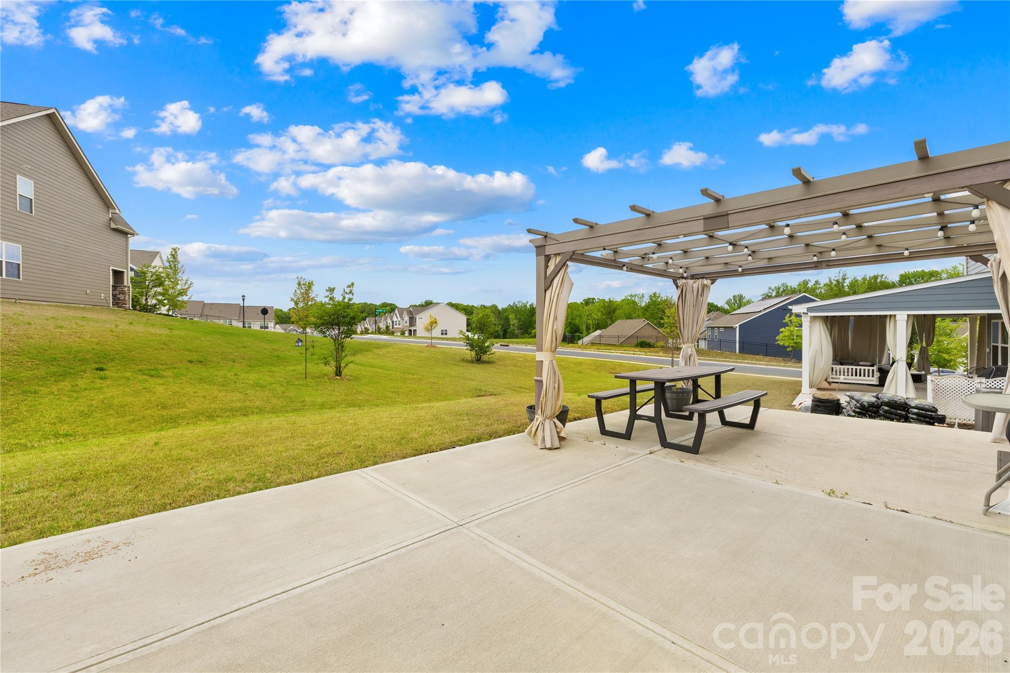 1741 Wildwood Terrace Trail Fort Mill, SC 29708 - Photo 41 of 47 a view of a patio with a table and chairs under an umbrella