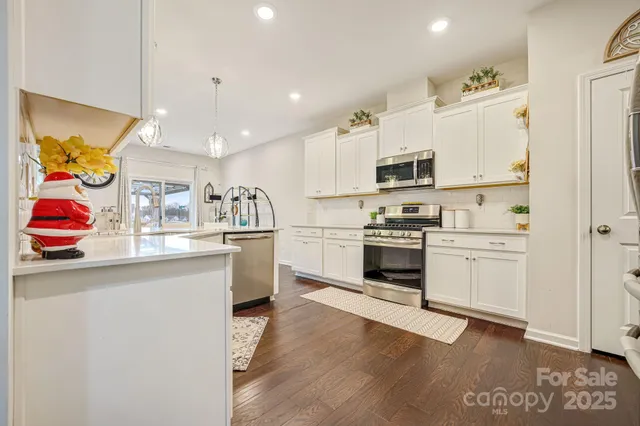 a kitchen with granite countertop a white stove top oven and sink