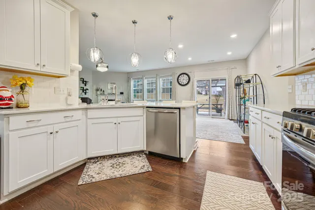 a kitchen with cabinets and window