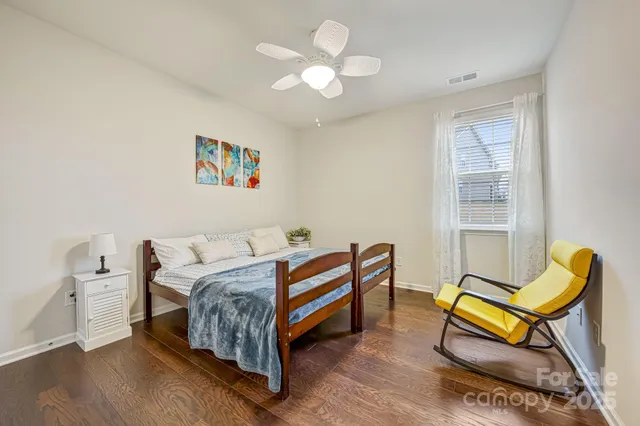 a bedroom with a bed and a chair