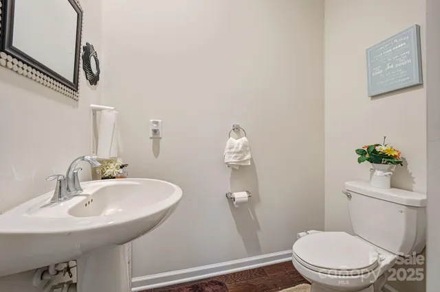 a bathroom with a sink a toilet and a mirror