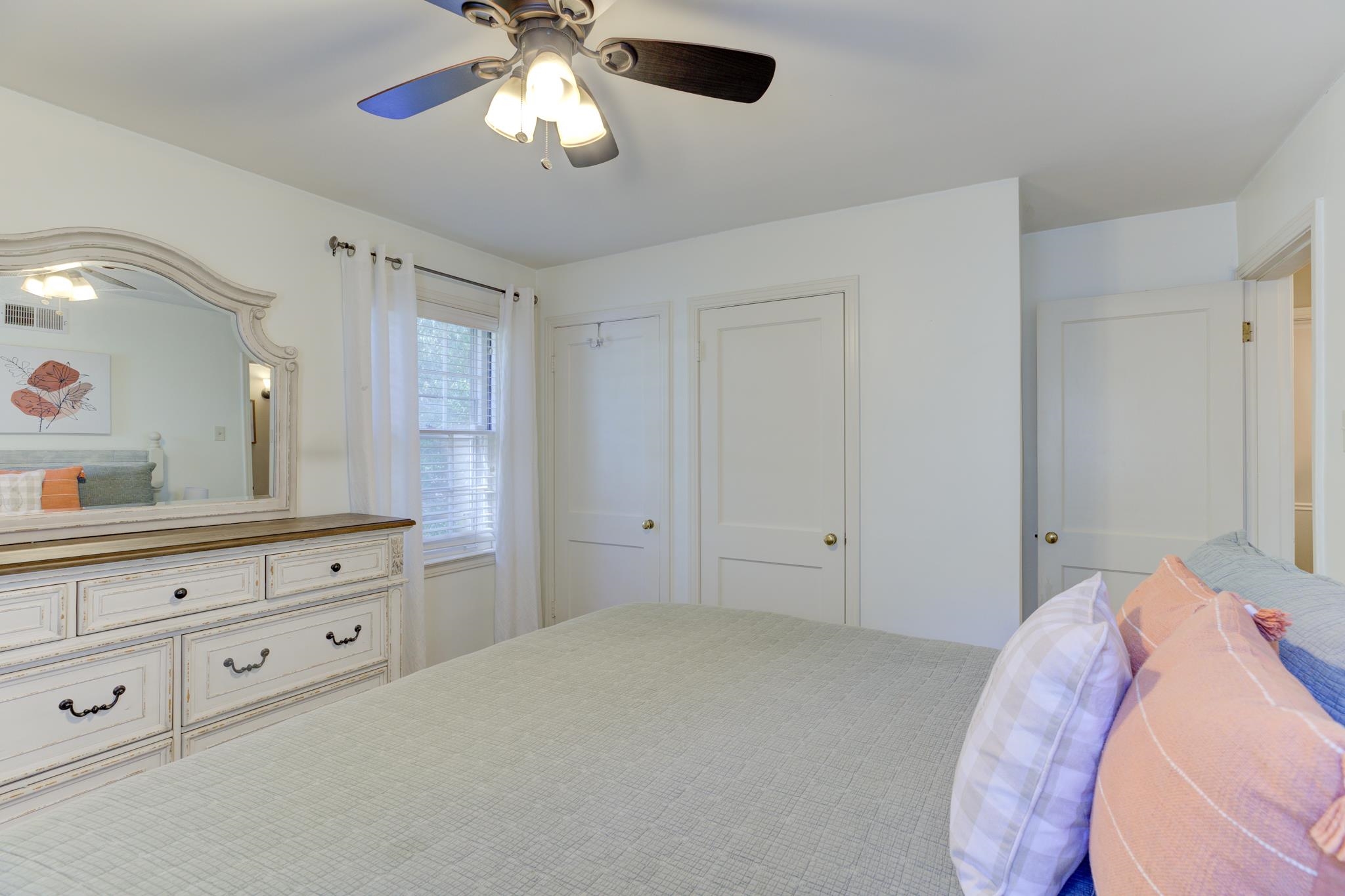 5030 New Castle Road Memphis, TN 38117 - Photo 10 of 25 a spacious bedroom with a large bed and a chandelier