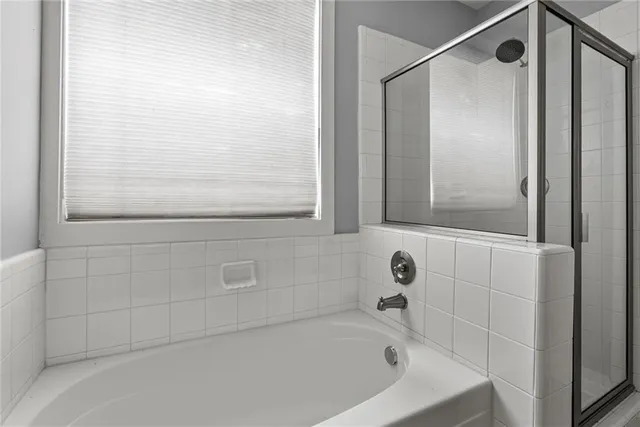 a bathroom with a tub and shower