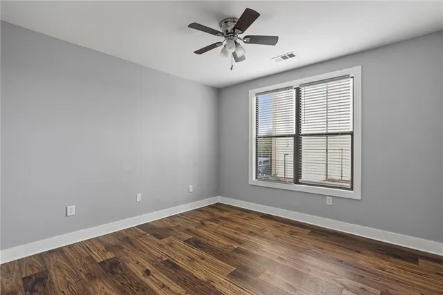 wooden floor in an empty room with a window